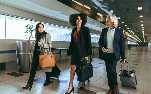 people going on business trip carrying suitcases